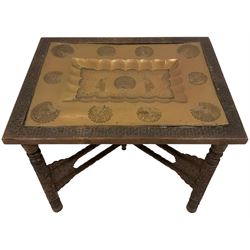 20th century Indian carved hardwood table, with inset brass tray decorated with peacocks, the folding base carved with flower heads