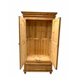 Pine double wardrobe, door enclosing interior fitted for hanging and with shelf, single drawer to base W109cm