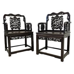 Pair of early 20th century Chinese carved hardwood armchairs, the shaped cresting rail with scroll decoration, the back pierced and carved with deer and bird motifs surrounded by foliate detail, the panelled seat over the carved and pierced frieze rail with flower head and branches trailing, raised on square supports united by stretchers