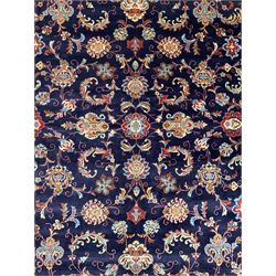 Persian indigo ground carpet, the field decorated with stylised plant motifs and trailing scrolling branches, similar design border surrounded by multiple guards with scrolling foliage and floral repeating patterns