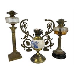 Early 20th century advertising oil lamp, the reservoir printed in blue and white 'Mortar Bluepill Practical Pharmaceutist'  H30cm, pair of brass wall sconces of scroll and leaf design and two brass column table oil lamps (5)