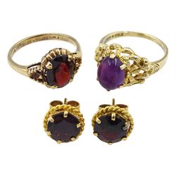 Gold oval cabochon amethyst ring in pierced setting, single stone garnet ring and a pair of garnet stud earrings, all hallmarked 9ct