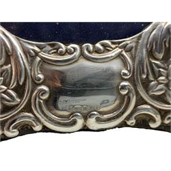 Pair of silver photograph frames with circular apertures and embossed with angels and cherubs, aperture size 12cm Sheffield 2004 Maker Carr & Co