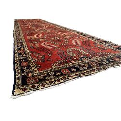 Persian Hamadan red ground runner, overall floral design, the field decorated with clusters of trailing flowerhead motifs, the border decorated with repeating pattern within guard bands