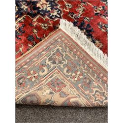Persian design red ground rug, the central field decorated with stylised foliate 184cm x 285cm