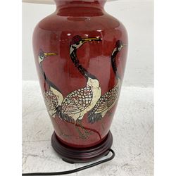 Pair of large table lamps of tapering form, decorated with cranes upon a red ground, upon circular footed base, H76cm 