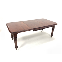 Edwardian mahogany extending dining table, moulded top raised on turned and fluted supports terminating in castors