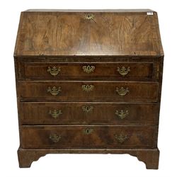 18th century walnut bureau, the fall front enclosing interior fitted with drawers and pigeon holes over four graduated drawers, raised on bracket feet 