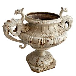 Pair of 19th century cast iron garden urns, shaped bowls mounted by Griffin shaped handles, on circular footed base moulded with stylised flower heads 