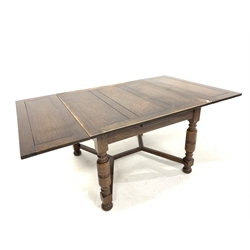 Early 20th century oak duo draw leaf dining table, top raised on turned supports united by castors, 107cm x 106cm, H75cm