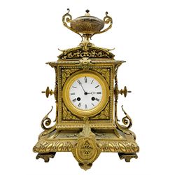 French brass cased mantle clock c1880 with a domed pediment surmounted by a twin handled urn, rectangular case with finials to the sides over a spreading rectangular base raised on four recessed feet, with a one-piece white enamel dial contained within a beaded bezel and conforming spandrels to the corners, Roman numerals and steel moon hands, eight-day twin train rack striking movement stamped Japy Freres, striking the hours and half-hours on a bell.
With key and pendulum
