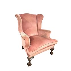 Victorian wingback armchair, upholstered in pale pink fabric with feather filled seat cushion, raised on ball and claw supports 