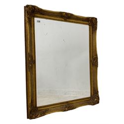 Large gilt framed mirror, moulded edge with cartouche decoration, rectangular bevelled plate