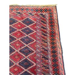 Meshwani indigo and maroon ground rug, the field decorated with connected central lozenges within geometric borders, the guard bands with repeating geometric and lozenge motifs
