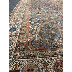 Central Asian design ground carpet, with repeating geometric decoration on blue field, enclosed by multi line border, 365cm x 180cm