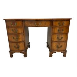 Georgian design serpentine mahogany twin pedestal desk, top with inset leather writing surface and mahogany crossbanding, fitted central frieze drawer flanked by eight graduation drawers, on bracket feet