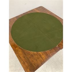 Victorian figured walnut fold over card table, the twist folding top opening to reveal baize playing surface, raised on a squared column leading into splayed and scrolled supports terminating in brass castors 