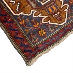 Small Persian Baluchi rug, decorated with geometric motifs within a shaped field, the spandrels decorated with plant patterns, scrolling border 