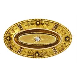 Victorian gold Etruscan revival old cut diamond brooch, the diamond star set within an oval frame with cannetille decoration, glazed locket back verso, stamped 15ct