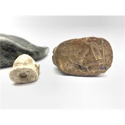 20th century Inuit soapstone carving of a Walrus with bone tusks, L16cm, carved chalk Shabti head, together with an Egyptian scarab sphinx seal (3)