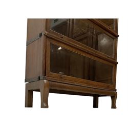 Globe Wernicke - early 20th century oak three sectional stacking library bookcase, each enclosed by glazed up-and-over doors, raised on cabriole feet