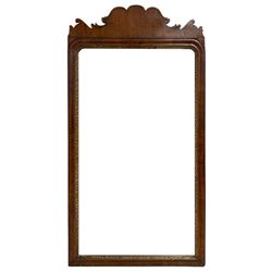 George III mahogany framed wall mirror, the shaped pediment over moulded frame with gilt and foliate carved inner slip, bevelled mirror plate
