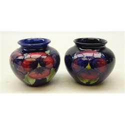 Two Moorcroft Pansy pattern baluster vases on blue ground, H7cm (2)