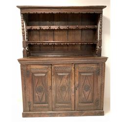 DD CHS - Antique welsh oak dresser, the carved raised back fitted with two shelves and eight turned hooks over base with cushion frieze and lozenge carved panel dated 1641, flanked by two matching panelled doors enclosing plain interior, on a skirted base W163cm