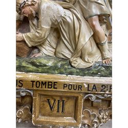 19th century French 'Stations of the Cross' hand painted plaster cast plaque, no. VII 'Jesus tombe pour la deuxième fois' (Jesus falls for the second time), with an architectural frame in a scumbled finish with lunettes over a foliate arch H110cm