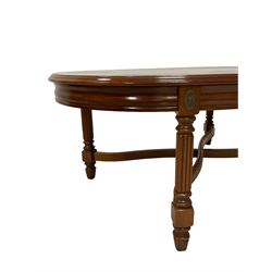 Mahogany coffee table, oval moulded top on square reeded supports joined by curved x-framed stretchers