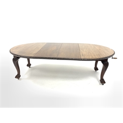 Early 20th century mahogany extending dining table, the oval top with floral edging over acanthus carved cabriole supports with ball and claw feet terminating in castors, two additional leaves, 122cm x 240cm, H75cm (Extended)