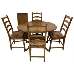 Ercol - elm oval extending dining table with additional leaf, on turned pedestal with four splayed cabriole supports (W111cm D98cm H73cm; together with set four Ercol elm and beech ladder back dining chairs (W46cm H99cm)