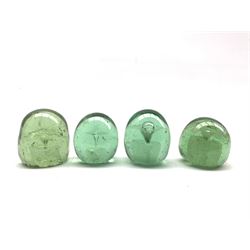 Four Victorian green glass dump paperweights with internal flower inclusion, tallest H7.5cm (4)