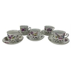 Set of five 18th century Meissen trembleuse cups and saucers, each hand painted with floral sprays, puce painted scroll handle, the saucers with tall reticulated gallery and chocolate rims, blue crossed swords mark beneath (10) Provenance: From the Estate of the late Dowager Lady St Oswald