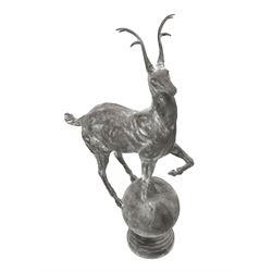 Pair of cast metal garden figures or gate post finials in the form of stags on spherical mounts
