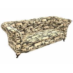Victorian chesterfield sofa, upholstered in Andrew Martin deep buttoned animal print velvet fabric, raised on turned supports with ceramic castors L200cm