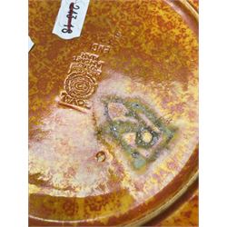 Royal Lancastrian lustre bowl, the centre decorated with a dragonfly in relief and chain pattern to the exterior, together with a mottled orange plate, both painted by Gladys Rodgers, bowl D18cm (2)