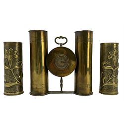 World War I Trench Art clock formed from two brass shell cases H28cm and a pair of Trench Art vases with a raised pattern of Art Nouveau flowers (3)