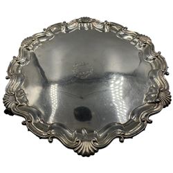 Victorian silver salver circular form with pie crust border and scroll and shell detail, raised upon four claw and ball feet, central engraved family crest and inscription beneath, by Martin, Hall & Co, London 1892, D37cm