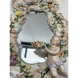 Pair Sitzendorf scroll shaped porcelain wall mirrors applied with flowers and Putti, H49cm x W29cm 