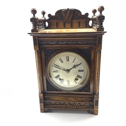  Late 19th century oak cased mantel clock, galleried top with shield and scroll carved raised back, the front carved with lunettes and cross hatched decoration, silvered circular Roman dial, twin train 'Winterhalder and Hofmeier' movement striking the hours and half and single coil, the movement stamp 'W&H, Sch', H37cm  