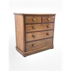 Early Victorian mahogany chest fitted with two short and three long drawers, raised on compressed bun supports 