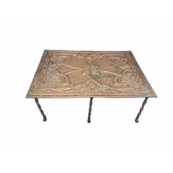 Scottish Arts and Crafts copper trivet of rectangular form with embossed Celtic design on twisted copper supports, L31cm 