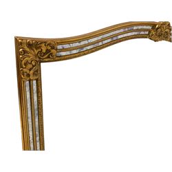 Deknudt Mirrors - Gilt cushion framed wall mirror, arched top with central stylised fleur-de-lis decoration and cartouche corners