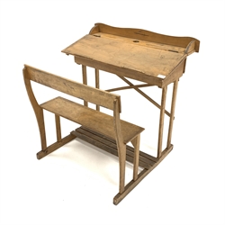 Mid 20th century child's school desk, raised back over ink well recess and pen wells, sloped front revealing storage area, connected to an integral bench seat, with traces of original blue paint,  W75cm, H78cm, D66cm