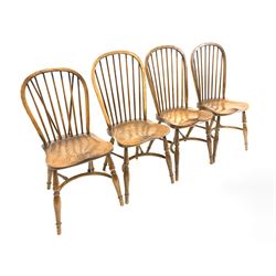Matched set four 20th century elm Windsor dining chairs, hoop and spindle back over saddle seat, raised on turned supports united by crinoline stretcher 