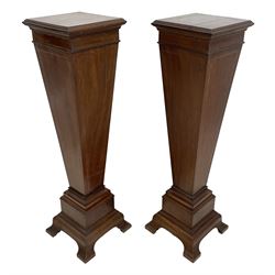 Pair Edwardian inlaid mahogany pedestals in the manner of Sheraton, moulded square top with chequered stringing, square tapering form with satinwood band, on stepped and moulded base with moulded bracket feet