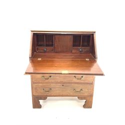 Edwardian mahogany bureau, the sloped fall front with satinwood band and shell inlay enclosing interior fitted with drawers and cupboard, over three graduated drawers and raised on bracket supports (W74cm) together with a pair of Regency design dining chairs with upholstered seat and back rests, raised on sabre supports (W44cm)