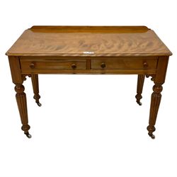 Victorian satinwood side table, raised back over rectangular top with moulded edge, fitted with two drawers over c-scroll brackets, on turned and reeded supports with ceramic castors