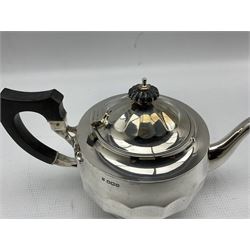 Silver three piece tea set of panel sided circular form, the teapot with ebonised handle and lift Sheffield 1927 Maker Cooper Bros. and a similar hot water jug Sheffield 1931 Maker Viners 38oz gross (4)